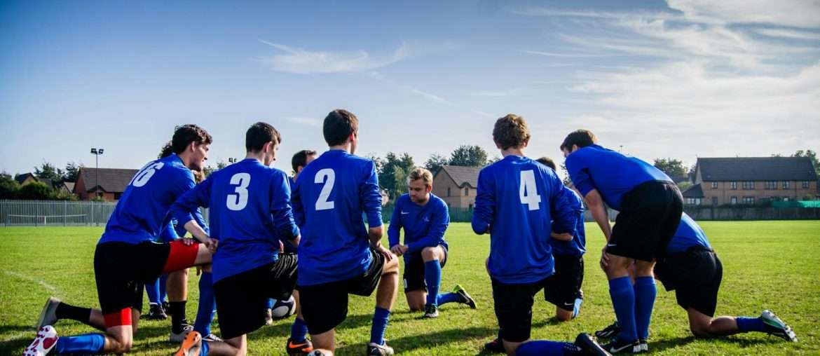 Group of Sports Player Kneeling on Field