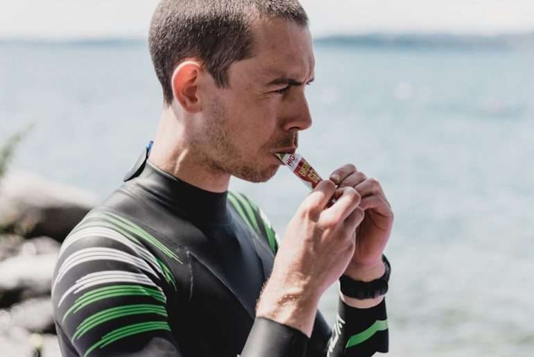 man in black and white long sleeve shirt smoking cigarette