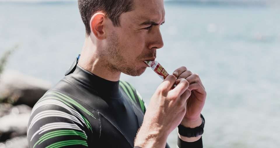 man in black and white long sleeve shirt smoking cigarette