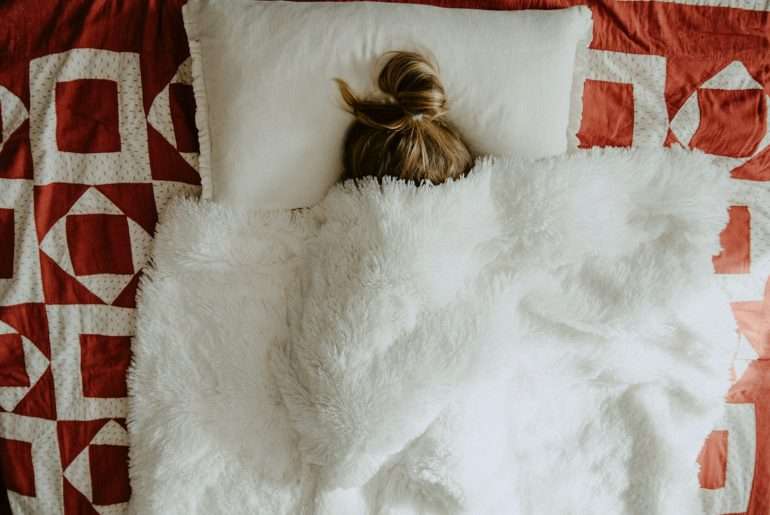 white fur textile on red and white textile