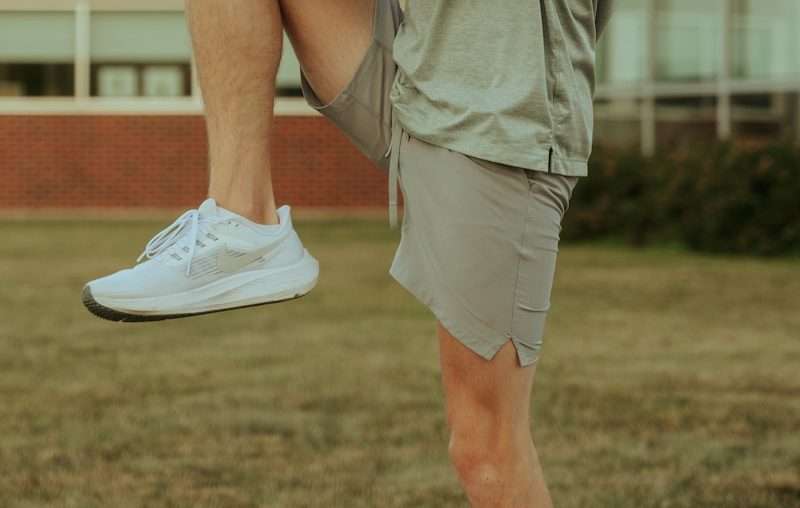 a man sitting on a skateboard on a sidewalk